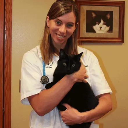 Dr. Audri Iverson of Dunes Animal Hospital, with black cat